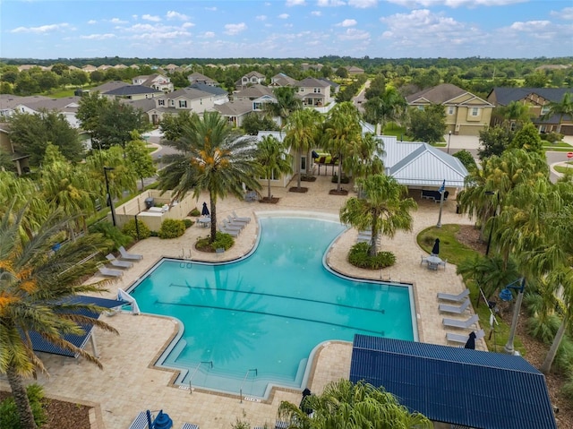 pool featuring a patio area, a residential view, and fence