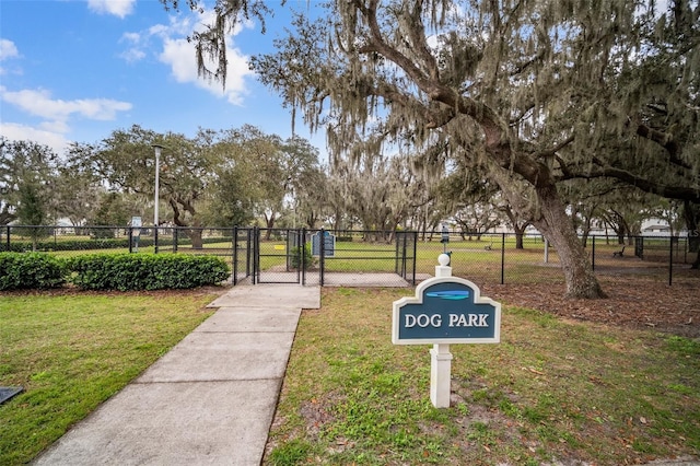 view of community with a gate, fence, and a lawn