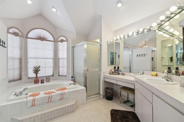 bathroom with lofted ceiling, a stall shower, a bath, and vanity