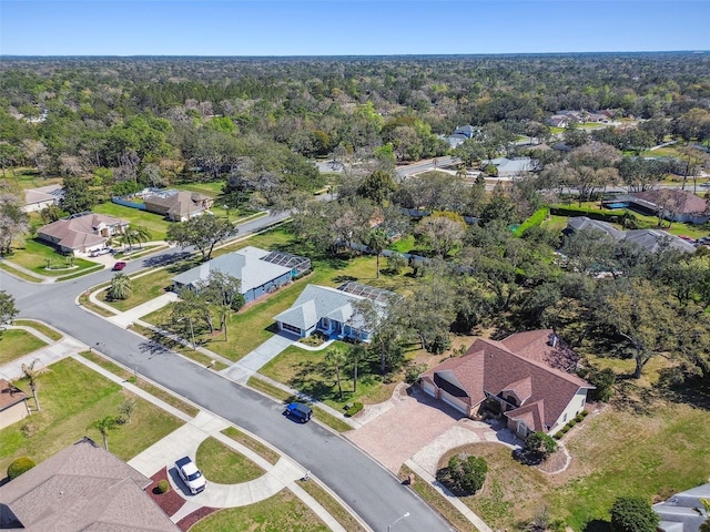 birds eye view of property with a residential view and a view of trees