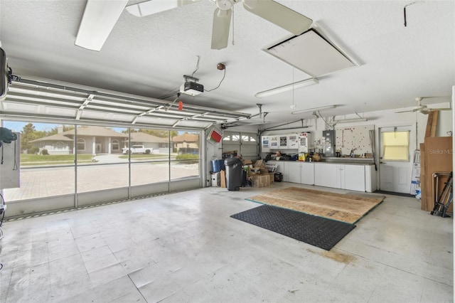 garage featuring ceiling fan and electric panel