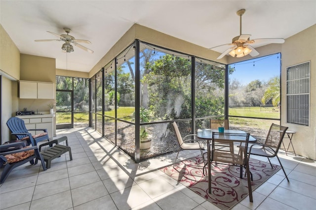 sunroom featuring a ceiling fan