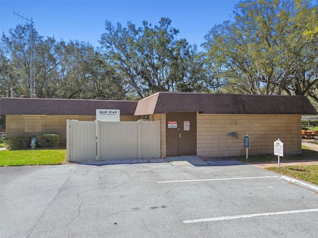 view of building exterior featuring uncovered parking