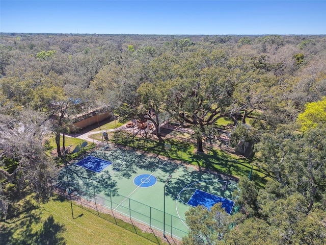 birds eye view of property featuring a view of trees