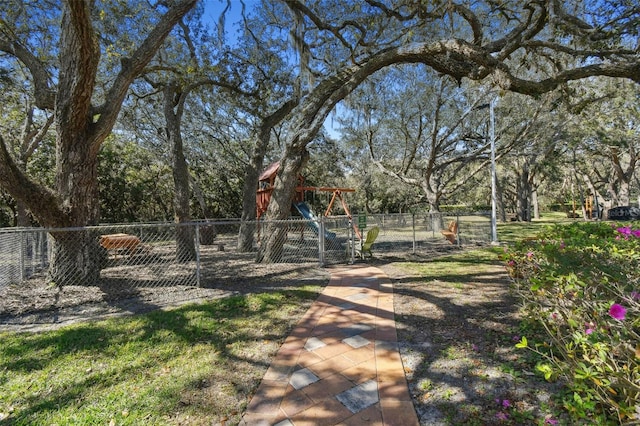 view of yard with fence and playground community