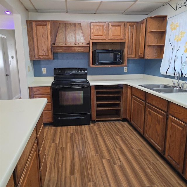 kitchen featuring dark wood-style floors, light countertops, black appliances, open shelves, and a sink