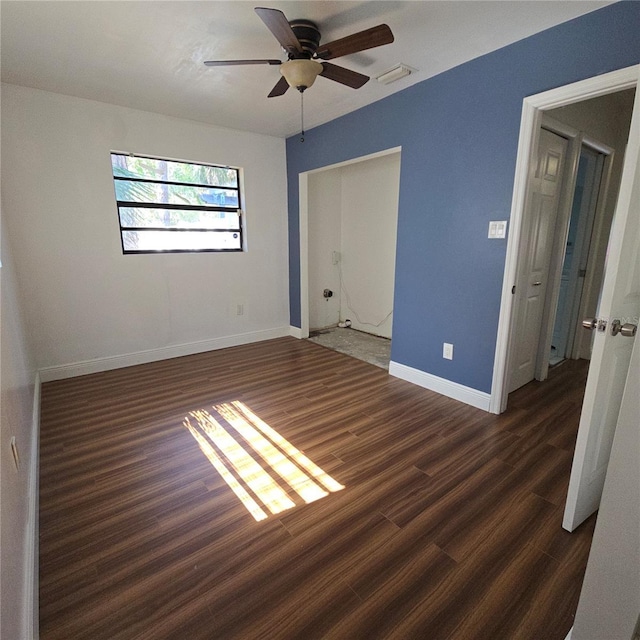 unfurnished bedroom featuring ceiling fan, baseboards, and wood finished floors