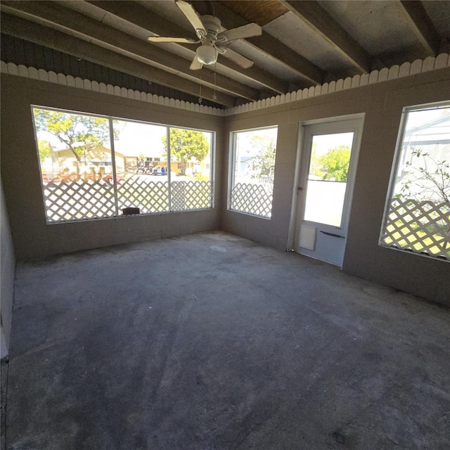 unfurnished sunroom with a ceiling fan