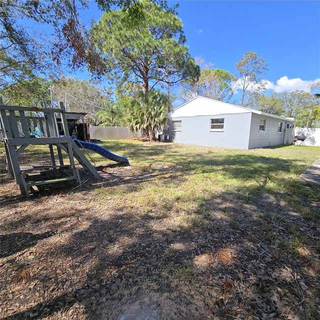 view of yard featuring a playground and fence