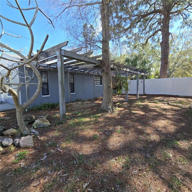 view of yard featuring fence and a pergola