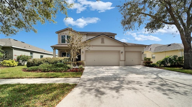 traditional-style home featuring a front lawn, driveway, an attached garage, and stucco siding