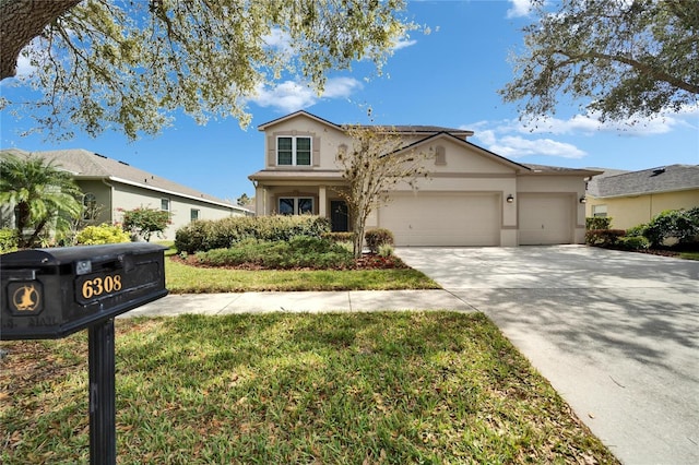 traditional home with a front lawn, concrete driveway, an attached garage, and stucco siding