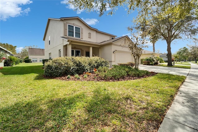 view of front of house with driveway, stucco siding, an attached garage, and a front yard