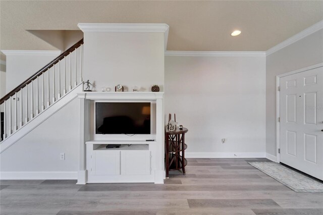 living area with baseboards, wood finished floors, stairs, crown molding, and recessed lighting