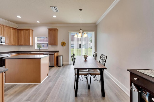 kitchen with visible vents, dark countertops, white microwave, a sink, and stainless steel dishwasher