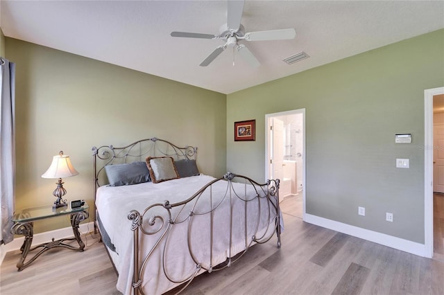 bedroom with visible vents, baseboards, and wood finished floors