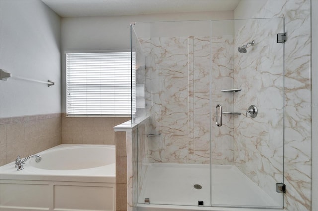 full bath with a garden tub and a marble finish shower