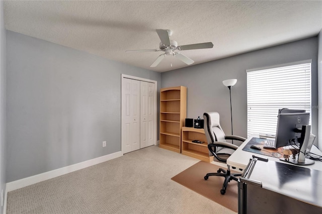 office area featuring carpet floors, ceiling fan, baseboards, and a textured ceiling