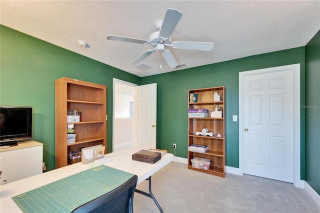 office space with carpet, a textured ceiling, baseboards, and a ceiling fan