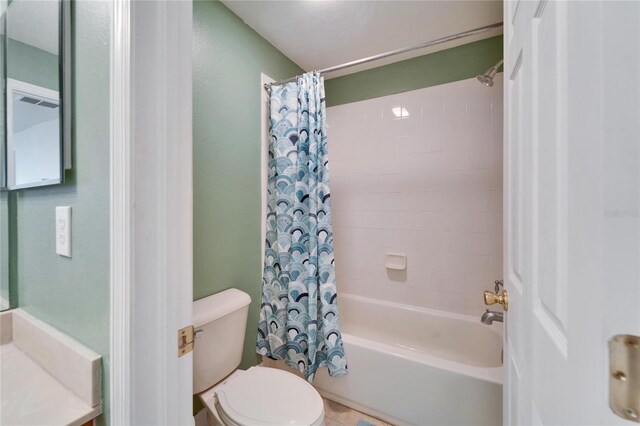 full bath featuring toilet and shower / tub combo with curtain