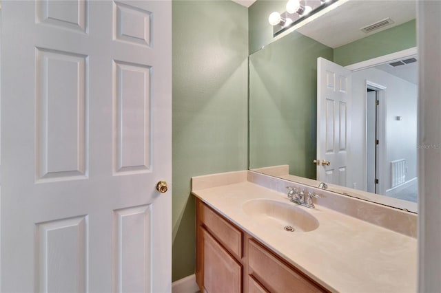 bathroom featuring visible vents and vanity