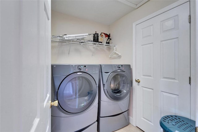 clothes washing area featuring laundry area and washing machine and clothes dryer