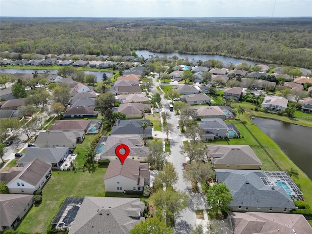 aerial view featuring a water view, a forest view, and a residential view