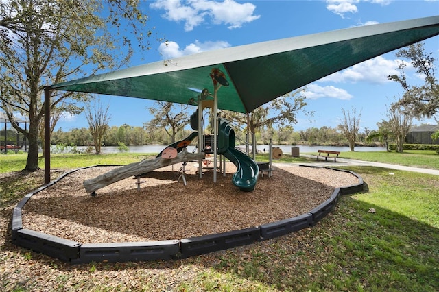 community playground featuring a water view and a lawn