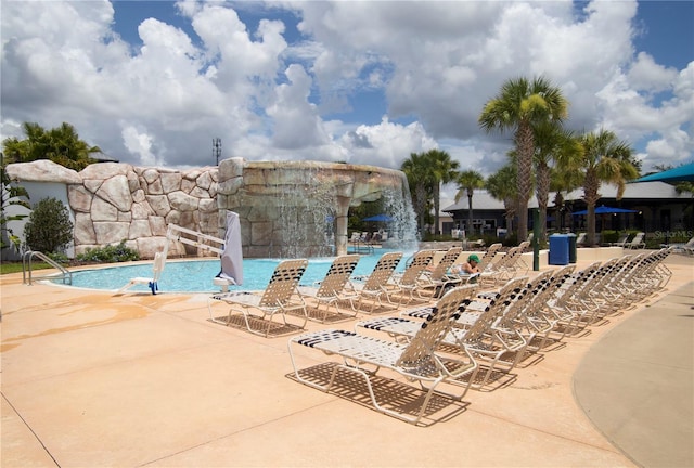 community pool with a patio area