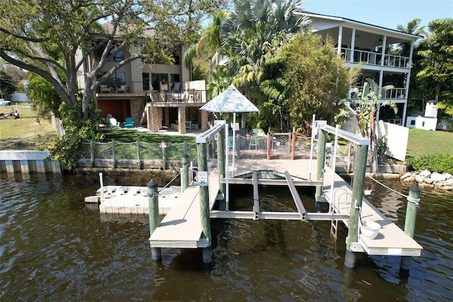 view of dock with a water view, stairway, boat lift, and fence