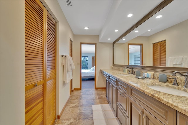 bathroom featuring recessed lighting, a closet, a sink, and baseboards