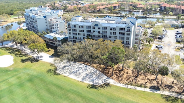 birds eye view of property with a water view and view of golf course