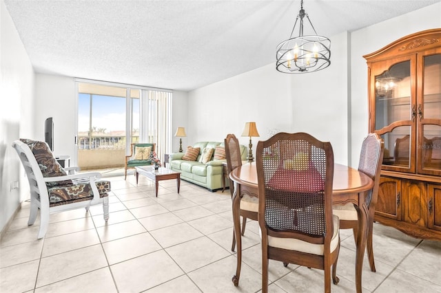 dining space with a chandelier, floor to ceiling windows, light tile patterned flooring, and a textured ceiling