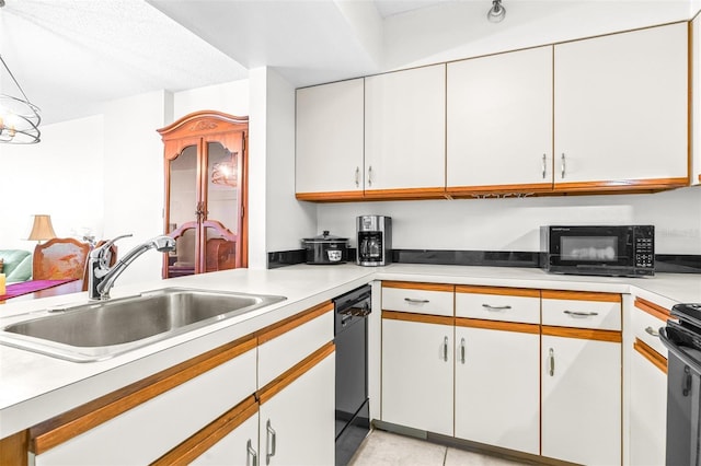 kitchen featuring light tile patterned floors, a sink, white cabinets, light countertops, and black appliances