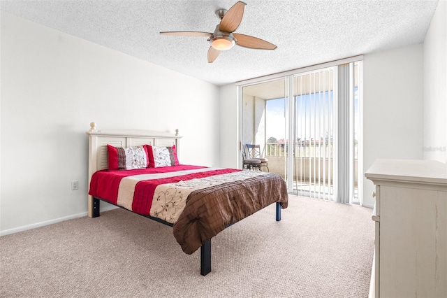 bedroom with a textured ceiling, carpet flooring, baseboards, access to exterior, and floor to ceiling windows