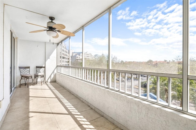 unfurnished sunroom featuring plenty of natural light and a ceiling fan