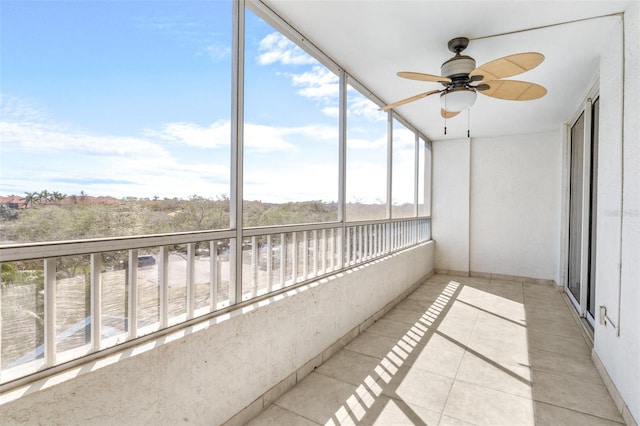 unfurnished sunroom with a ceiling fan