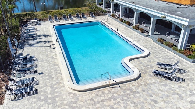 community pool featuring a patio area and a water view