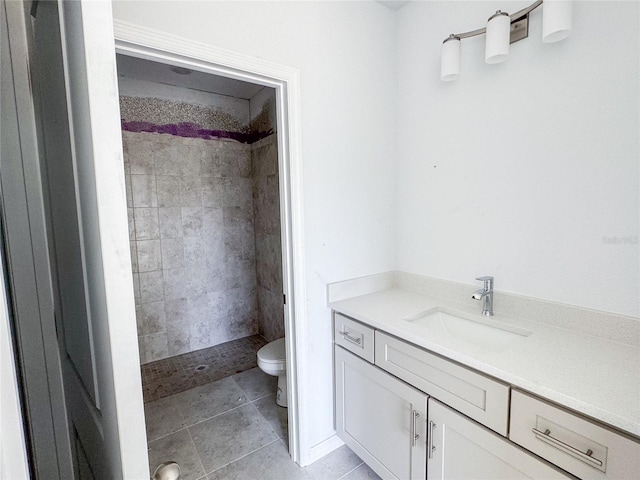 full bathroom featuring toilet, a shower stall, tile patterned flooring, and vanity