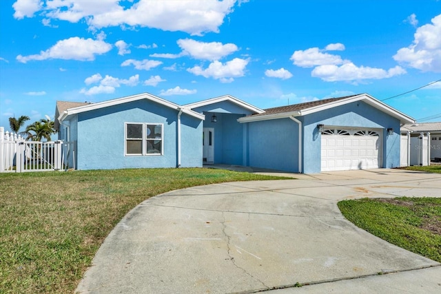 ranch-style house with a garage, fence, concrete driveway, stucco siding, and a front yard