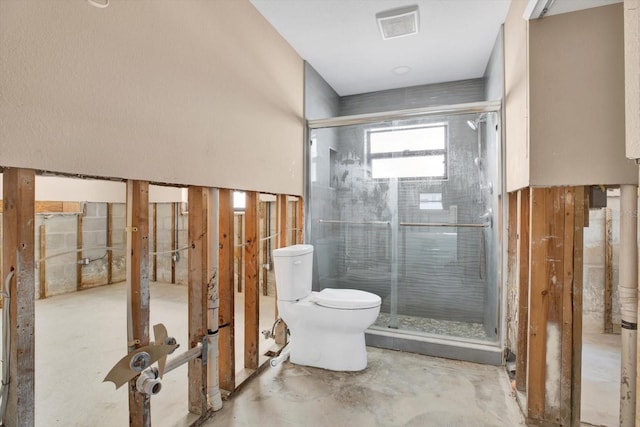 bathroom with visible vents, a shower stall, and toilet