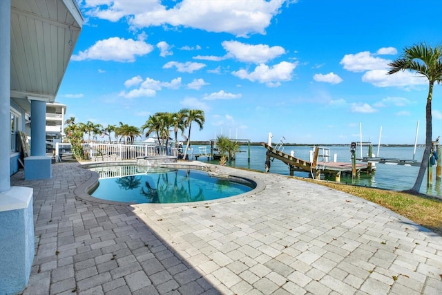 view of pool featuring a patio, a boat dock, a water view, and boat lift