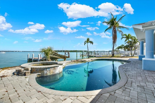 view of swimming pool with a patio area, a dock, a water view, and a pool with connected hot tub