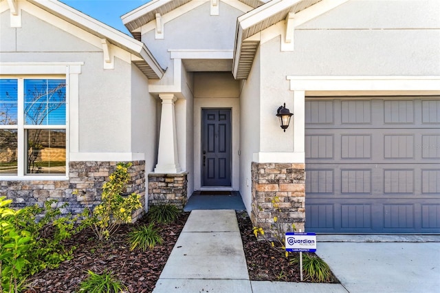 doorway to property with stone siding and stucco siding