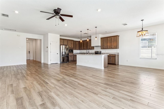 kitchen featuring ceiling fan, visible vents, open floor plan, appliances with stainless steel finishes, and light wood-type flooring