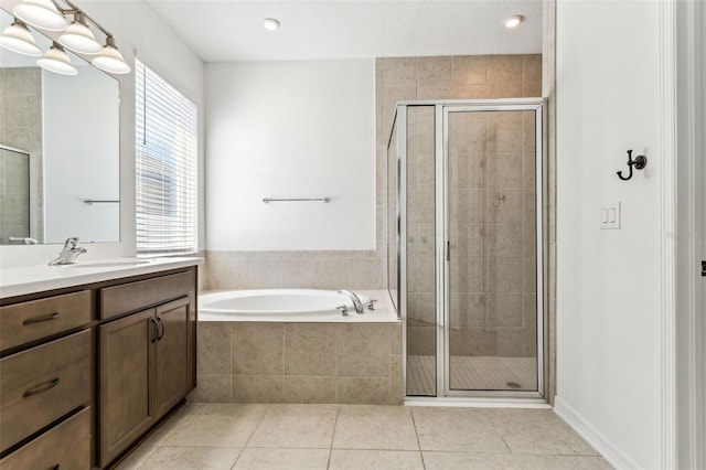 bathroom with vanity, a shower stall, a bath, and tile patterned floors