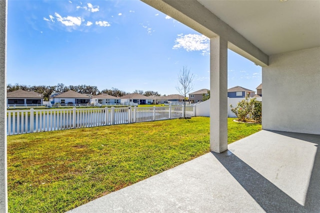 view of yard with a residential view, a patio area, a water view, and fence private yard