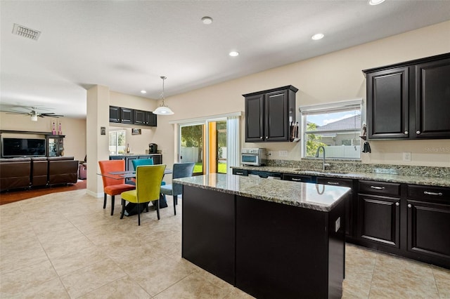 kitchen with dark cabinets and a sink