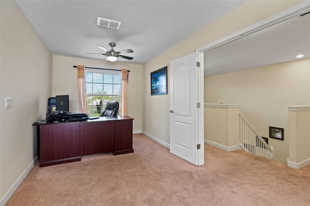 office space featuring carpet floors, baseboards, and visible vents