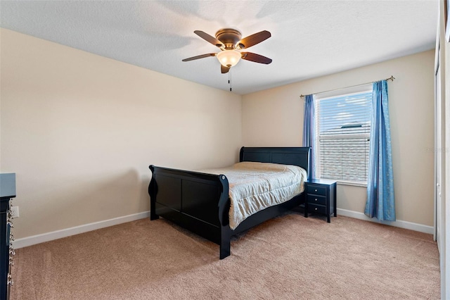 bedroom with light carpet, ceiling fan, and baseboards